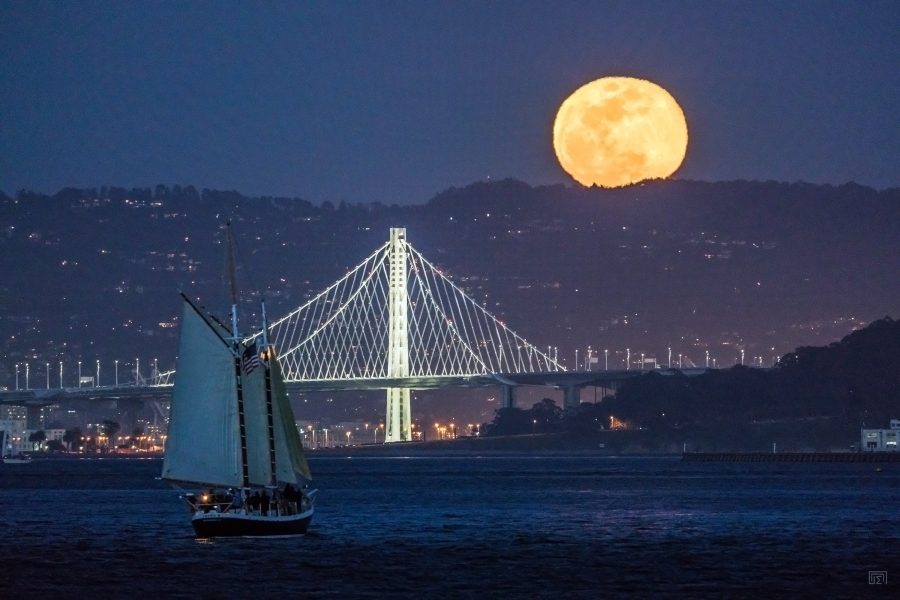 Schooner Freda B sailing in front of Bay Bridge during Full Moon on San Francisco Bay